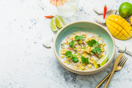 Raw scallops with mango and pineapple in coconut milk, thai style, copy space