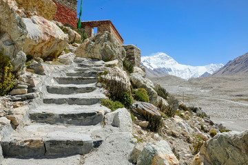 CLOSE UP: Scenic shot of stairs leading up to Buddhist monastery under Everest