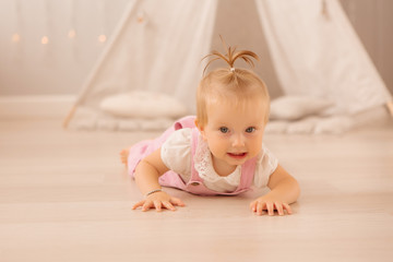 baby girl in the nursery playing,bright children's room, textiles for children's room