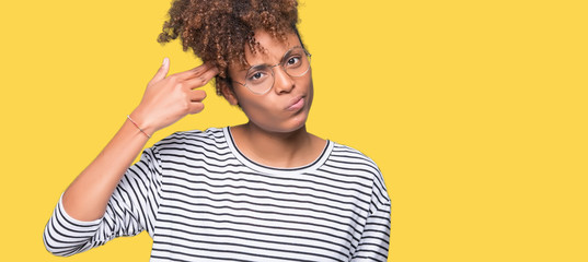 Beautiful young african american woman wearing glasses over isolated background Shooting and killing oneself pointing hand and fingers to head, suicide gesture.