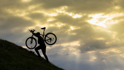 Fototapeta na wymiar Bicycle man silhouette at sunset.