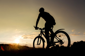Fototapeta na wymiar Bicycle man silhouette at sunset.