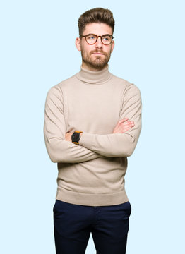 Young handsome business man wearing glasses smiling looking side and staring away thinking.