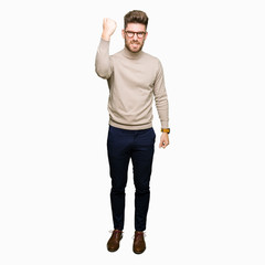 Young handsome business man wearing glasses angry and mad raising fist frustrated and furious while shouting with anger. Rage and aggressive concept.