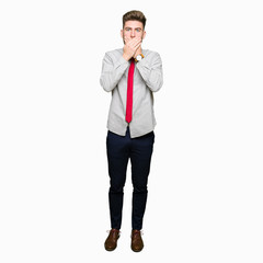 Young handsome business man shocked covering mouth with hands for mistake. Secret concept.