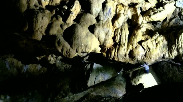 Beautiful nature caves - The Grottes de Remouchamps, Belgium. Popular tourist destination. Image of a stone wall in an underground grotto with a combination of stalactites and stalagmites. 4K