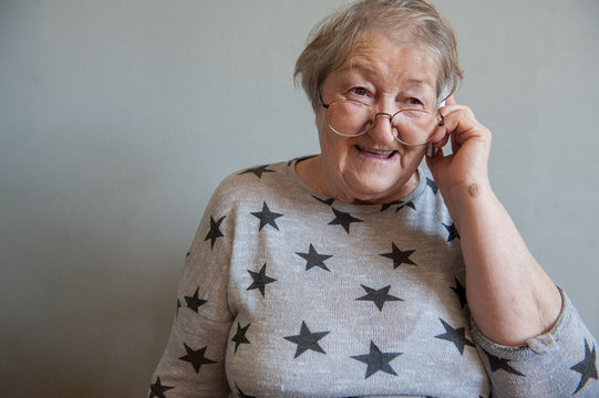 elderly retired woman with hearing impairment received hearing aid of latest modification in center of social protection and tries it on. Help for pensioners and people with disabilities