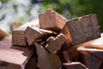 Natural wooden background, closeup of chopped firewood. Pile of wood logs on nature background