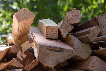 Natural wooden background, closeup of chopped firewood. Pile of wood logs on nature background