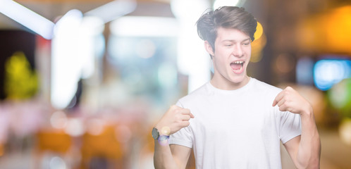 Young handsome man wearing casual white t-shirt over isolated background looking confident with...