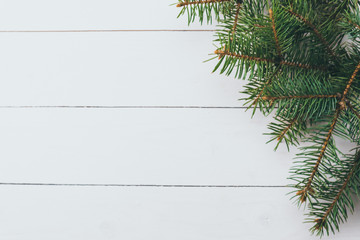 Fir tree twigs on wooden background. Christmas concept