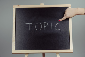 Topic written in white chalk on a black chalkboard
