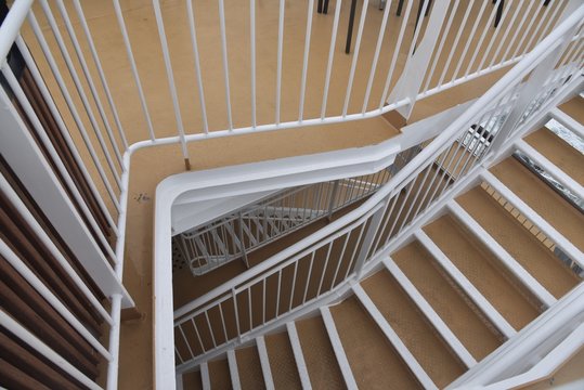 Endless white iron spiral staircases in a cruise ship - Powered by Adobe
