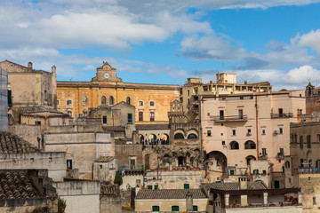 Fototapeta na wymiar Italy, Basilicata, Province of Matera, Matera. Old stone buildings on a steep hillside.