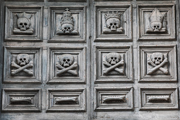 Italy, Basilicata, Province of Matera, Matera. Chiesa del Purgatorio. Skulls and bones carved into the wooden door.