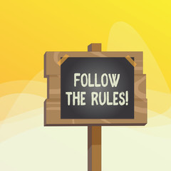 Writing note showing Follow The Rules. Business concept for go with regulations governing conduct or procedure Wood plank wood stick pole paper note attached adhesive tape