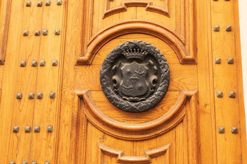 Italy, Apulia, Province of Lecce, Lecce. A coat of arms on a door.