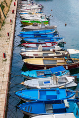 Fototapeta na wymiar Italy, Apulia, Province of Lecce, Gallipoli. June 03, 2019. Fishing boats tied up to piers in the Old City.