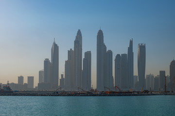 Fototapeta na wymiar Dubai marina in a morning haze. View from Jumeirah island. May. 2019