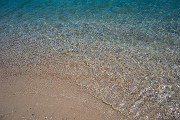 Natural background with water and rocks on the shore.