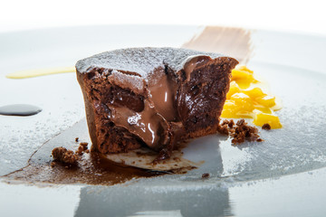 sliced brown cupcake with chocolate filling and sugar powder