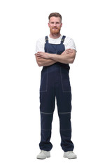 in full growth. confident bearded man in overalls .