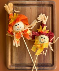 scarecrows on a wooden  surface 