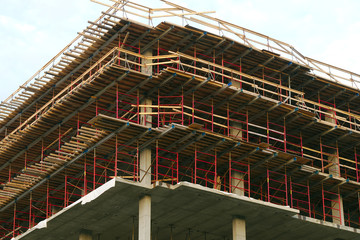 skyscraper construction site building structure wood beams and concrete frame