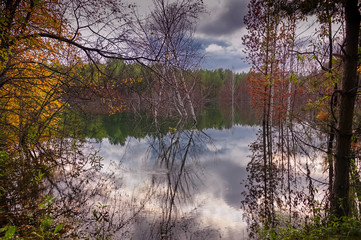 Autumn landscape sunset in the forest near the lake in the Ural Mountains