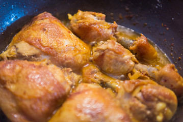 Chicken meat frying in pan