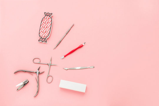 Manicure Concept Set On Pink Background. Tools For Perfect Nails, Polishing Nail Buff, Cuticle Pusher, Cuticle Trimmer, Nail File, Nail Scissors, Toes Separator, Nail Clippers, Toenail Clippers.