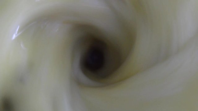 glass of blender spinning yellow juice of passion fruit with high speed