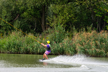 Teenager wakeboarding on a lake - Brwinow, Masovia, Poland