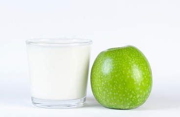 GREEN APPLE AND MILK GLASS ON WHITE BACKGROUND. HEALTHY DIET FOOD