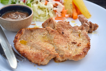  Pork steak with vegetable salads and sauces is a delicious and popular dish.