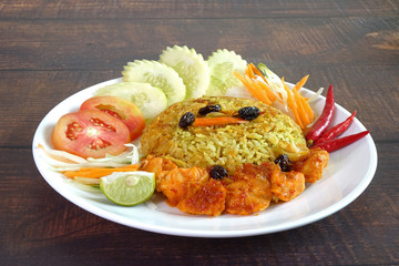 Briyani rice with Sweet spicy chicken curry (Nasi Briyani dengan Ayam Masak Merah), the famous Malaysian cuisine. Halal food. Selective fous, copy space.