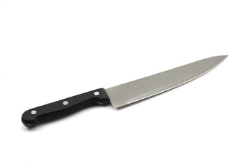 A macro, close up image of a black handled, stainless steel chef's knife shot against an isolated white background