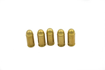 A close up macro image of golden handgun bullets isolated on a clean, white background