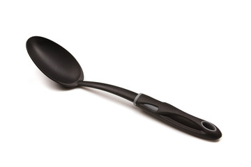 A close up image of a black cooking spoon isolated on a clean, white background