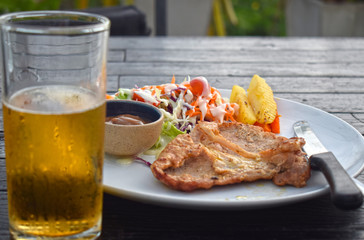  Pork steak with vegetable salads and sauces is a delicious and popular dish.