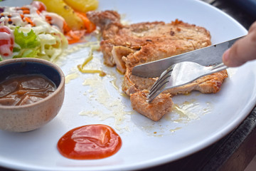  Pork steak with vegetable salads and sauces is a delicious and popular dish.