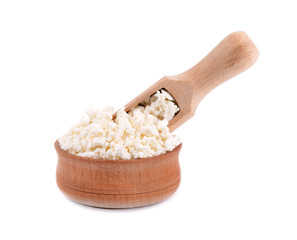 Cottage cheese in a wooden bowl isolated on a white background.