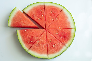 Watermelon sliced and cut into wedges - obrazy, fototapety, plakaty