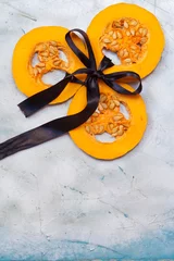 Schilderijen op glas Holiday foods and Feasts. Pumpkin slices decorated with black ribbon. Halloween and Happy Thanksgiving concept © Golib Tolibov