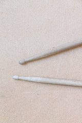 Vertical picture of old used drumsticks on a light background