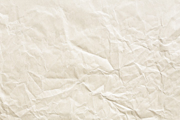 Old pale brown crumpled paper background texture