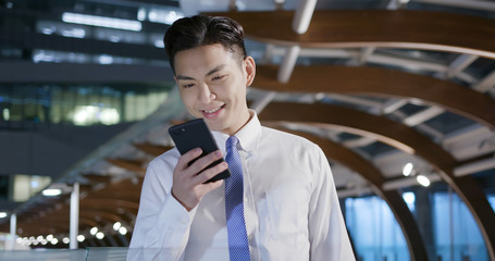 businessman use phone while walking