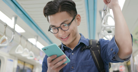 man use phone in MRT