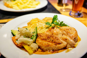 Grilled chicken steaks with vegetables on dinner time