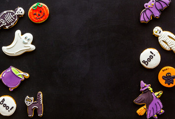 Halloween cookies in shape of spooky figures frame on black background top view mock up